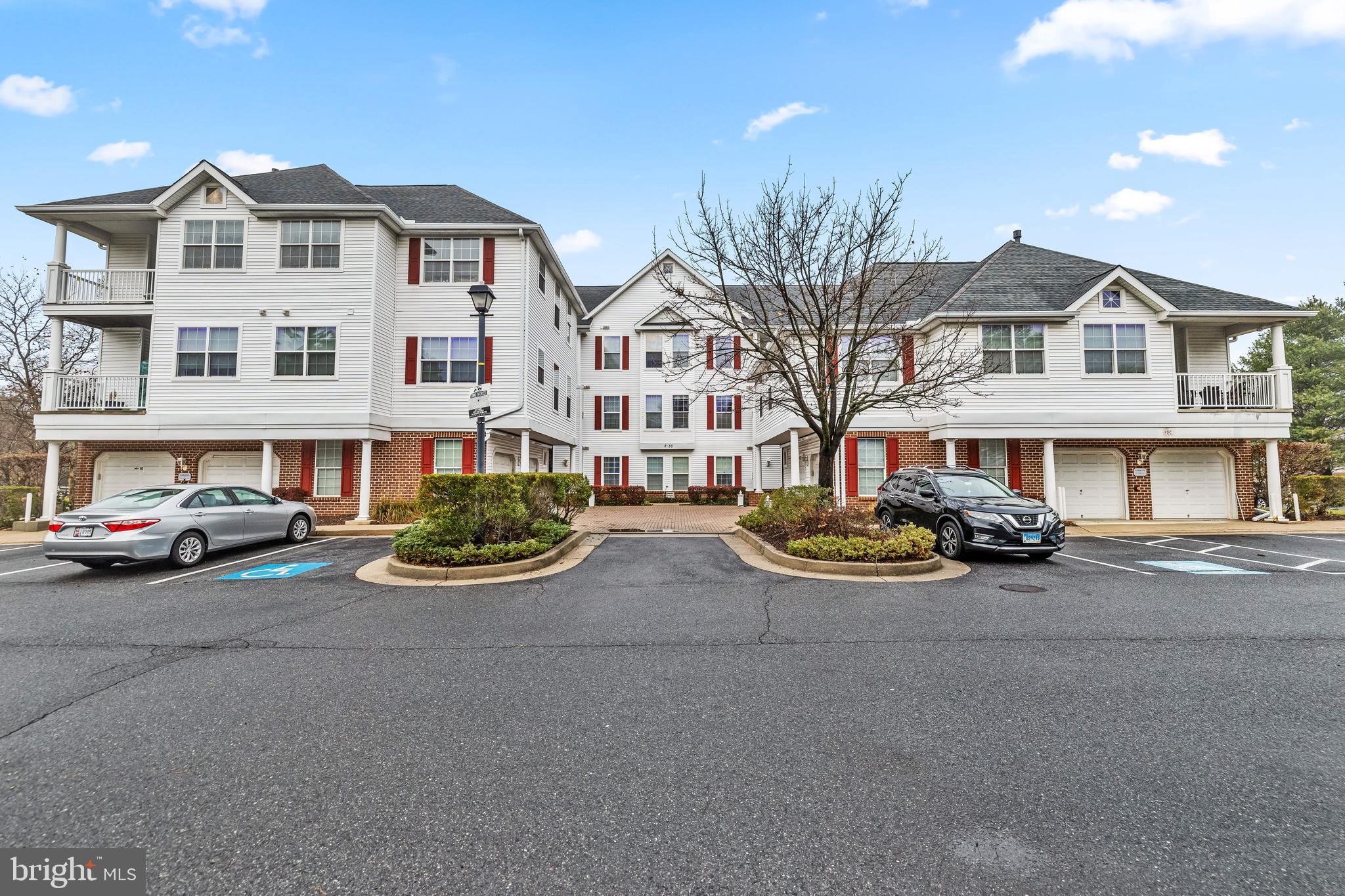 16 Hawk Rise Lane, Unit 204 Owings Mills, MD 21117 - Photo 2 of 33 a front view of a house with yard and a tree