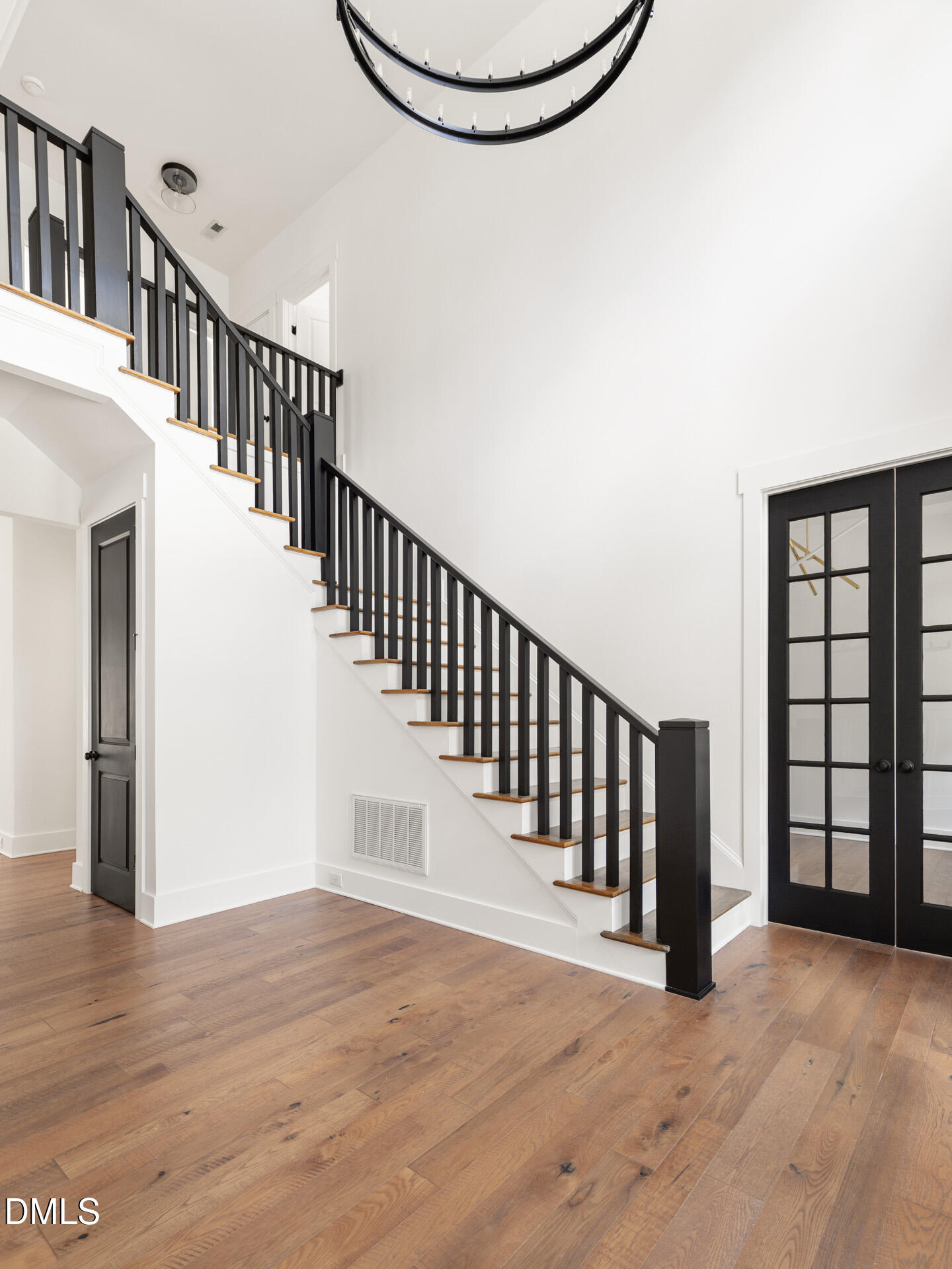 1117 Barley Stone Way Raleigh, NC 27603 - Photo 9 of 59 a view of staircase with wooden floor and white walls