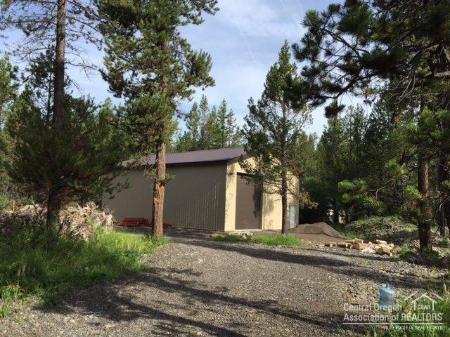 17002 Fontana Road Bend, OR 97707 - Photo 2 of 4 a front view of a house with a yard and garage