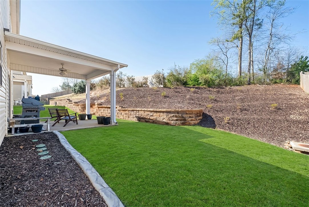 216 Carvel Trail Seneca, SC 29678 - Photo 43 of 46 Enjoy outdoor living with a covered patio and a lush, green lawn perfect for relaxation.