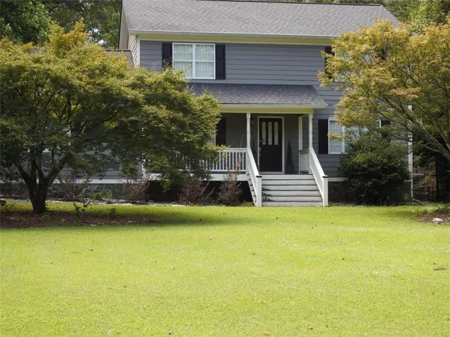 a view of a house with pool and a yard