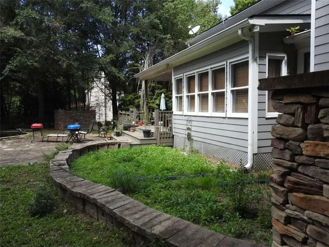 a view of a house with a large window and balcony
