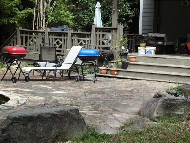 a backyard of a house with large trees and garage