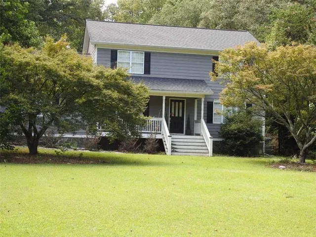 a view of a house with swimming pool and sitting area