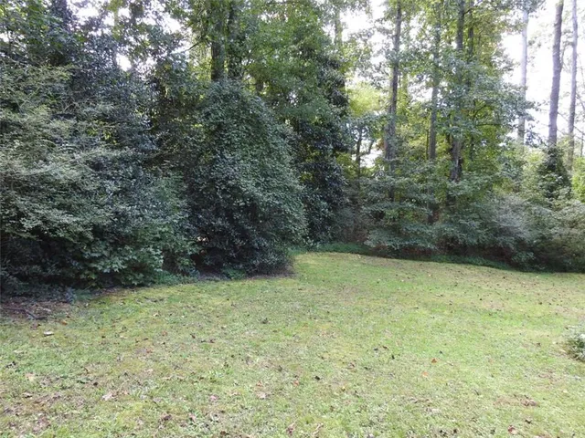 a view of house with backyard