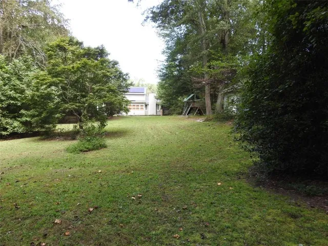 a backyard of a house with table and chairs