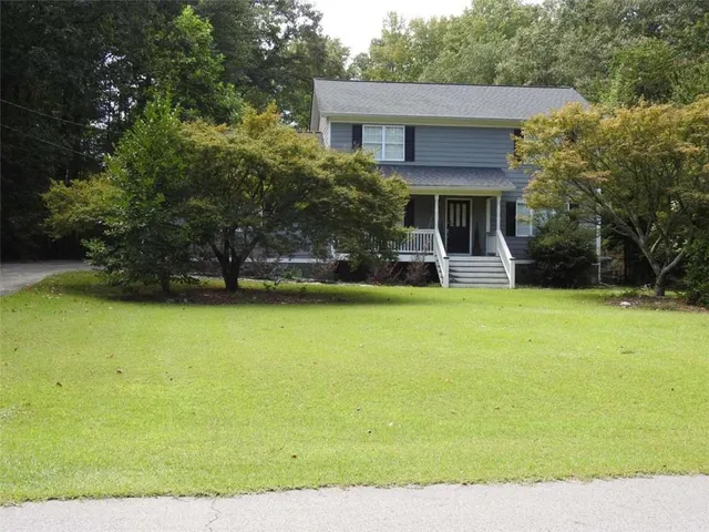a front view of a house with garden
