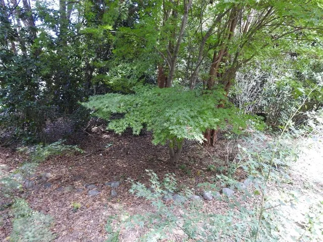 a bedroom with a bed and a flat tv screen on dresser