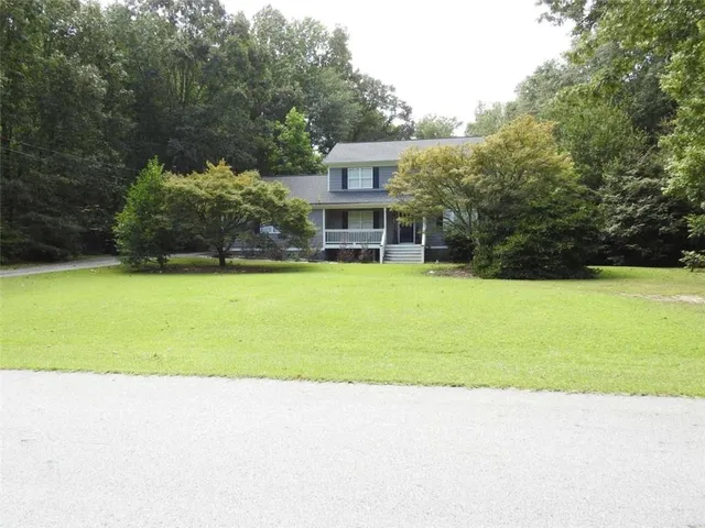 a view of a house with a yard and a garden