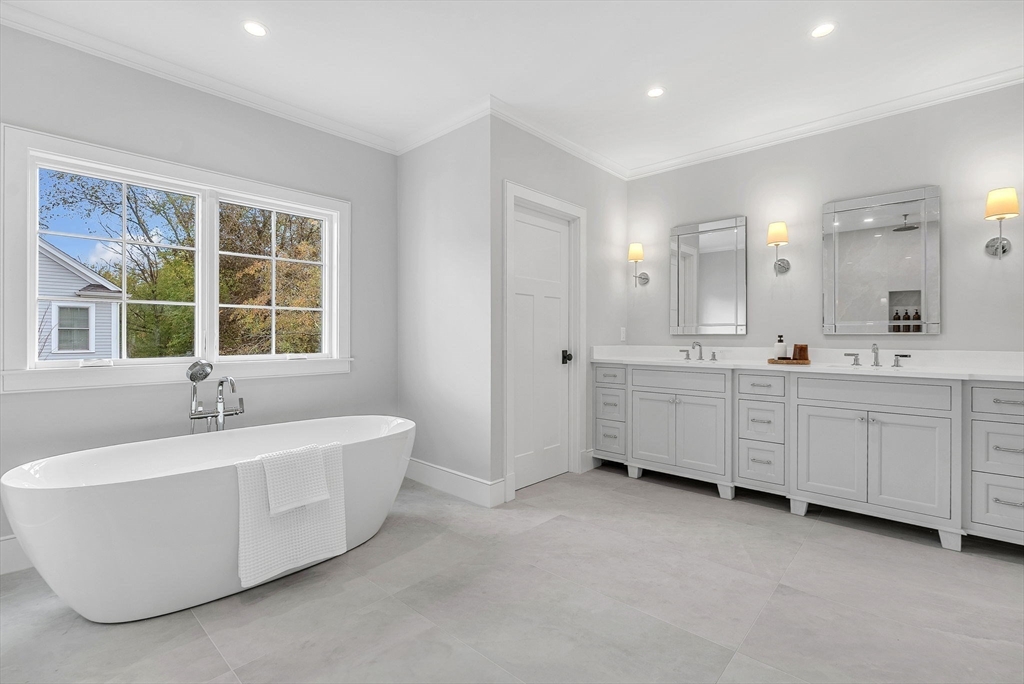 51 Boulder Brook Road Wellesley, MA 02481 - Photo 15 of 39 a spacious bathroom with a double vanity sink a large mirror and a bathtub