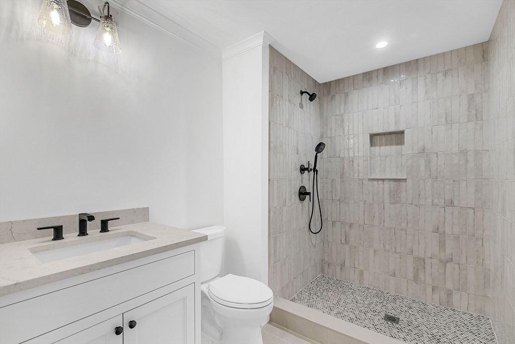 51 Boulder Brook Road Wellesley, MA 02481 - Photo 33 of 39 a bathroom with a granite countertop sink a toilet and shower