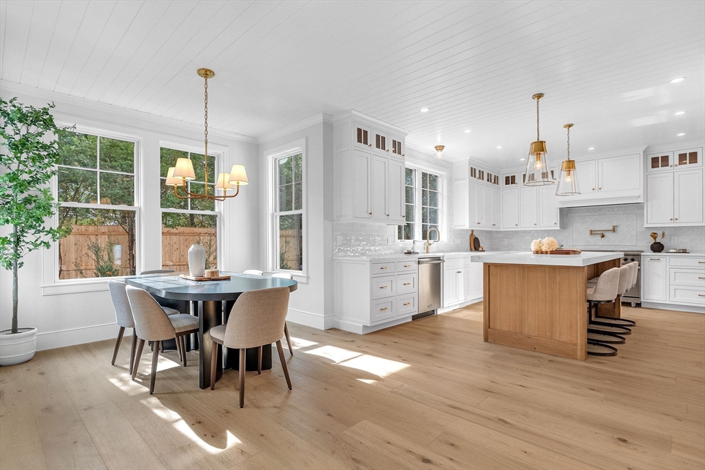 51 Boulder Brook Road Wellesley, MA 02481 - Photo 6 of 39 a kitchen with kitchen island stainless steel appliances a table chairs sink and wooden floor