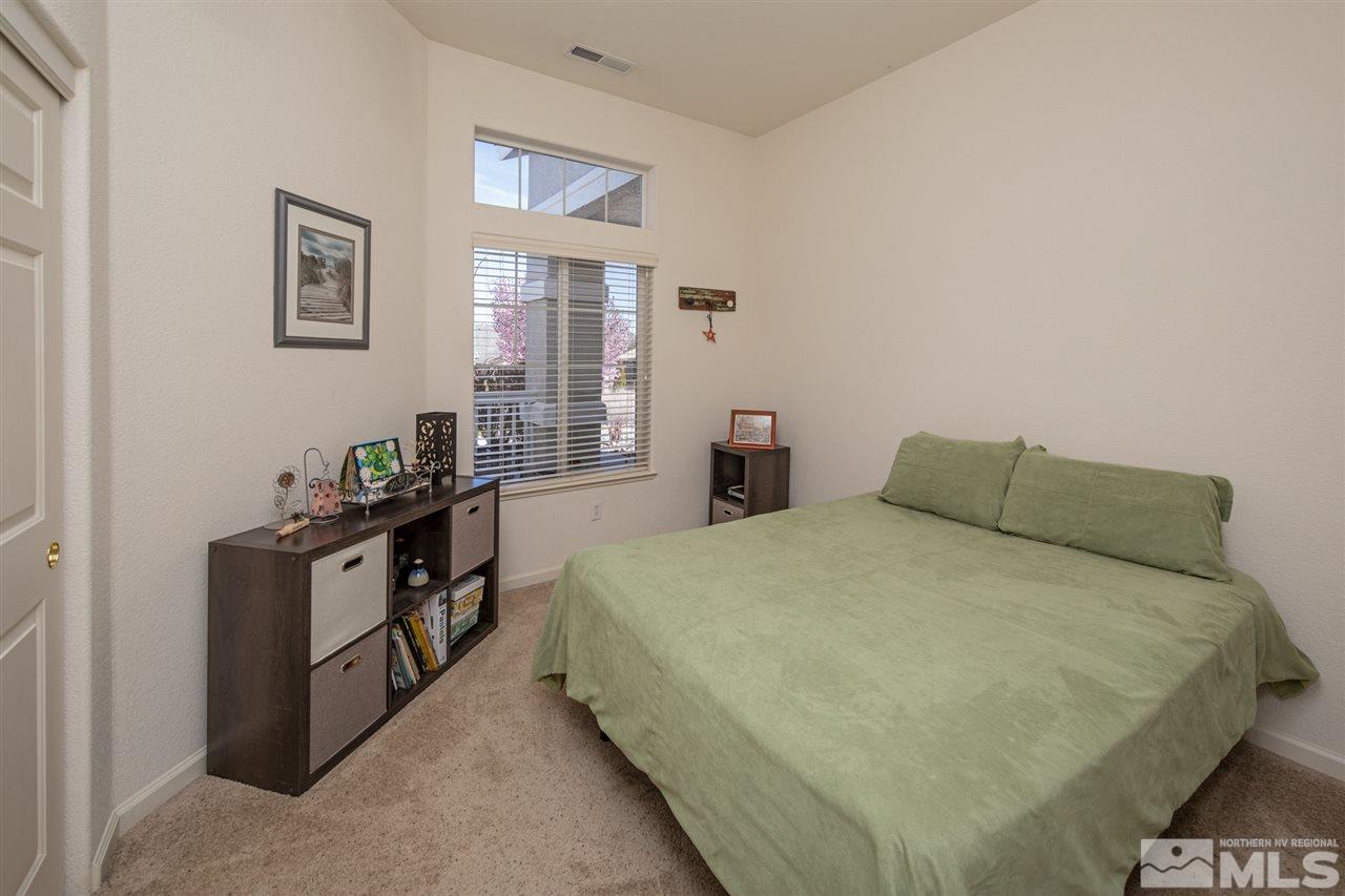 1448 Orca Way Reno, NV 89506 - Photo 2 of 9 a bed sitting in a bedroom next to a window