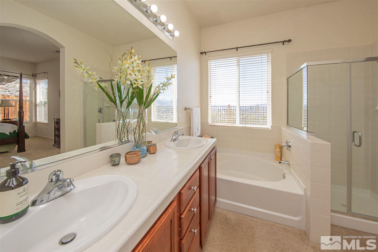 1448 Orca Way Reno, NV 89506 - Photo 4 of 9 a bathroom with a tub sink and mirror