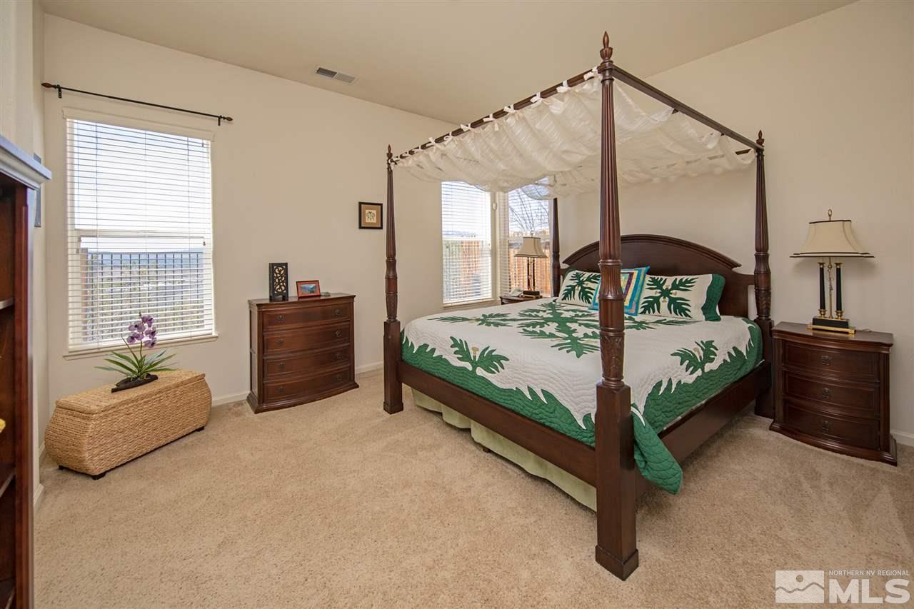 1448 Orca Way Reno, NV 89506 - Photo 5 of 9 a bedroom with a bed and a couch