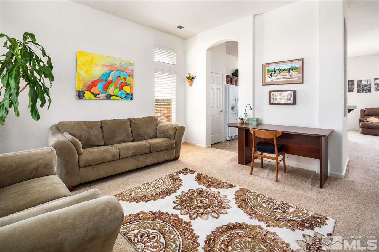 1448 Orca Way Reno, NV 89506 - Photo 6 of 9 a living room with furniture and painting on the wall