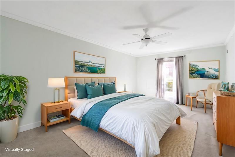 6851 Roswell Road, Unit D14 Atlanta, GA 30328 - Photo 13 of 30 a bed room with a bed and a chair