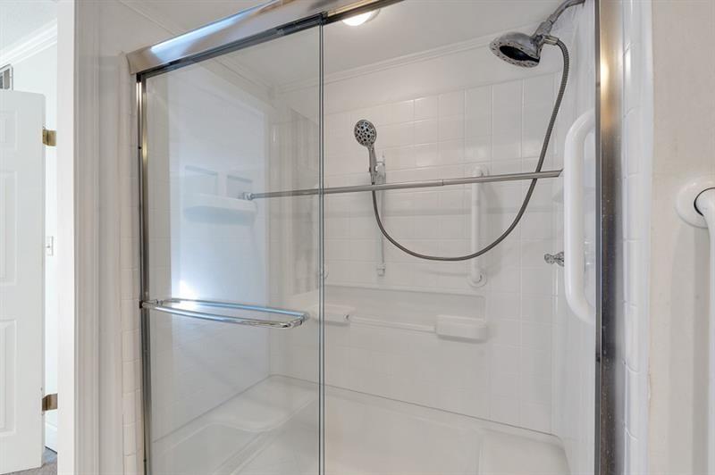 6851 Roswell Road, Unit D14 Atlanta, GA 30328 - Photo 19 of 30 a bathroom with a glass shower door
