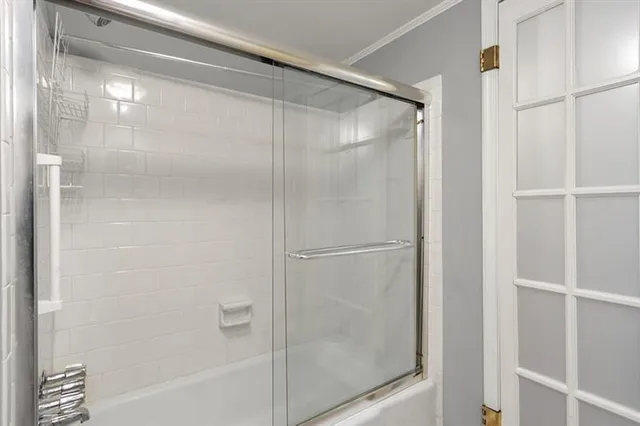a bathroom with a glass shower door