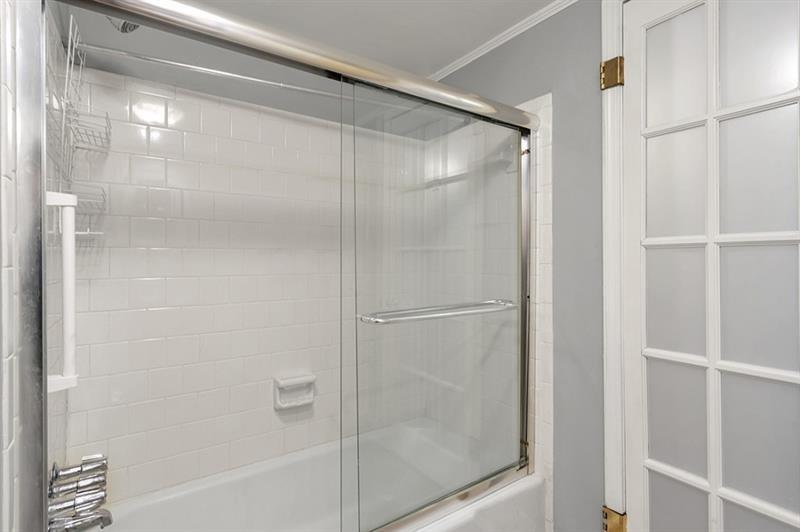6851 Roswell Road, Unit D14 Atlanta, GA 30328 - Photo 24 of 30 a bathroom with a glass shower door