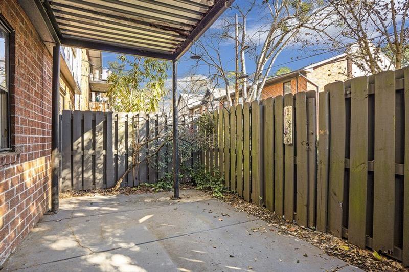 6851 Roswell Road, Unit D14 Atlanta, GA 30328 - Photo 25 of 30 a view of a pathway of a house with a tree