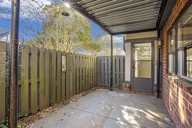 6851 Roswell Road, Unit D14 Atlanta, GA 30328 - Photo 26 of 30 a view of a house with a wooden bench