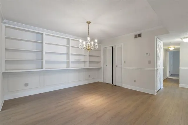 a view of an empty room with a chandelier