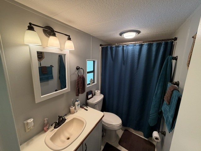 2795 East 28th Road Marseilles, IL 61341 - Photo 15 of 63 a bathroom with a toilet a sink and mirror