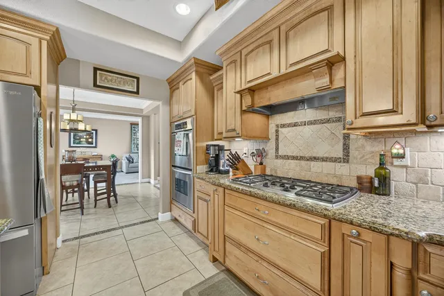 a kitchen with stainless steel appliances granite countertop a stove and a cabinets