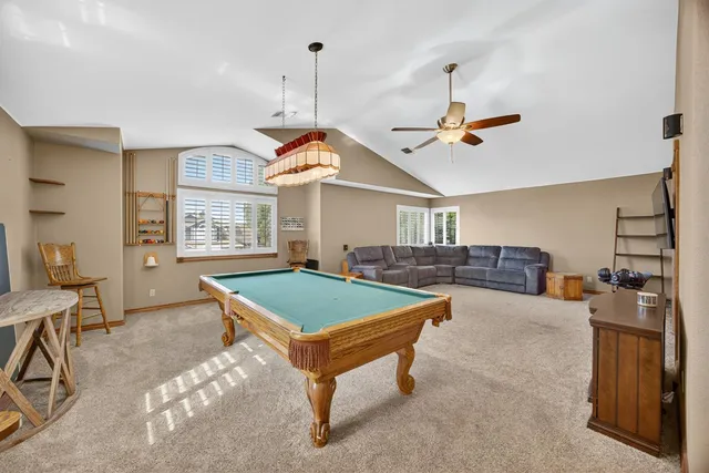 a room with pool table and windows