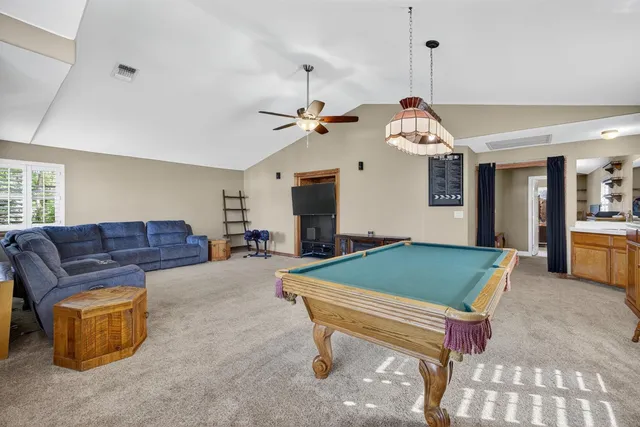 a living room with furniture and kitchen view
