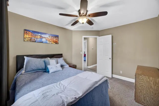 a bedroom with a large bed and a chandelier