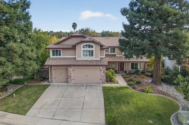an aerial view of a house with a yard