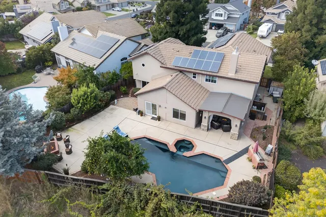 an aerial view of residential house with outdoor space and parking