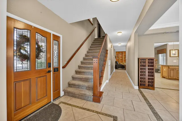 a view of a hallway with wooden floor and stairs