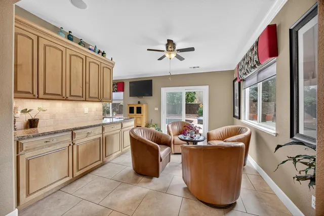 a kitchen with kitchen island granite countertop a sink and dishwasher with a dining table