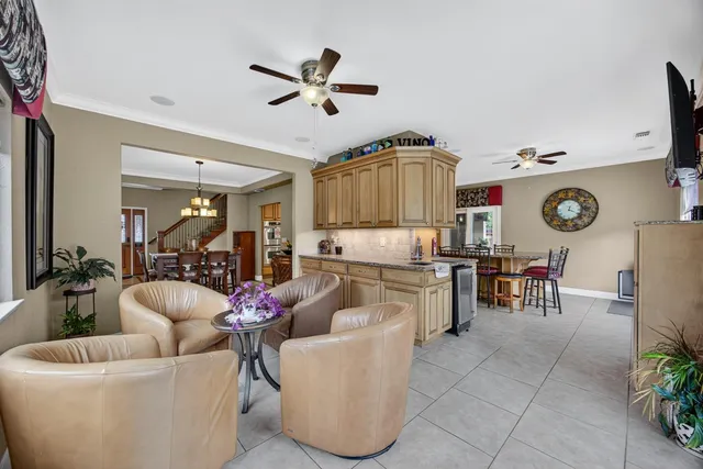 a living room with furniture and kitchen view