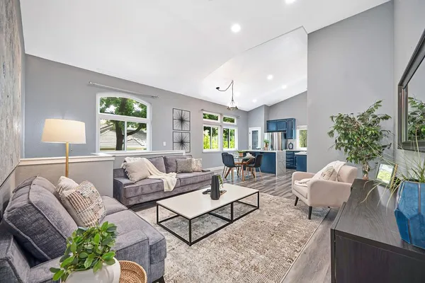 a living room with furniture a window and a potted plant