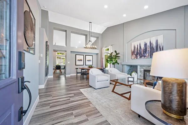 a living room with furniture a chandelier and a window