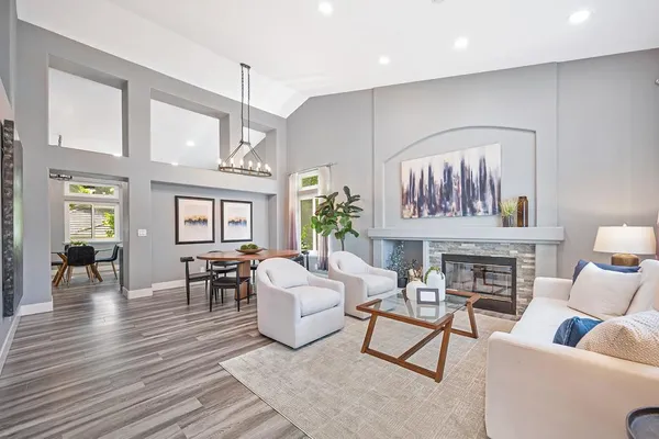 a dining room with furniture potted plants and wooden floor