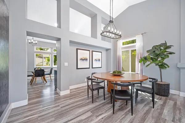 a kitchen with stainless steel appliances a stove top oven a sink dishwasher and wooden cabinets with wooden floor