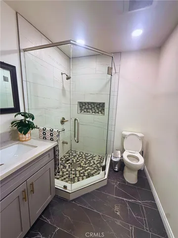 a bathroom with a sink toilet and shower