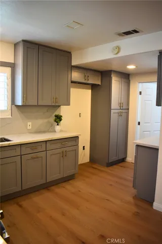 a kitchen with granite countertop cabinets and refrigerator