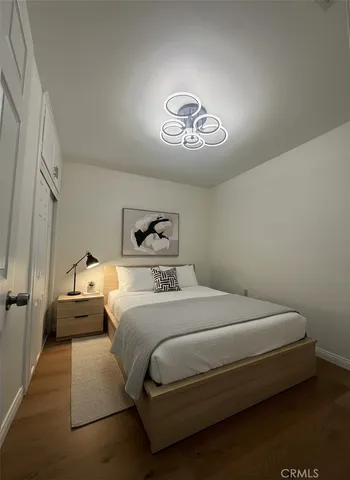 a bedroom with a bed and a chandelier