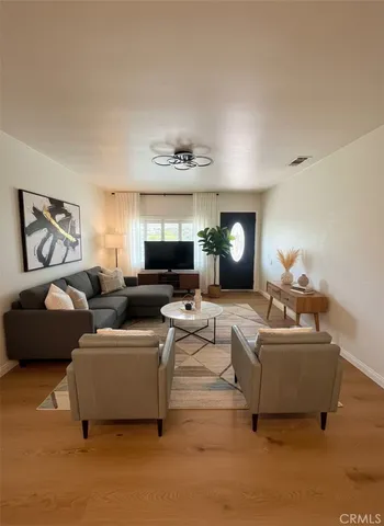 a living room with furniture and a large window
