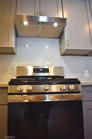 a stove top oven sitting inside of a kitchen