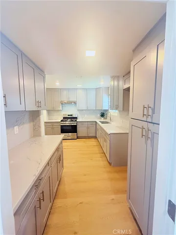 a kitchen with stainless steel appliances granite countertop a refrigerator sink and cabinets