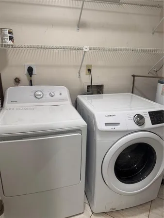 a utility room with dryer and washer