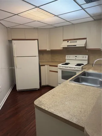 a kitchen with a sink a stove and refrigerator