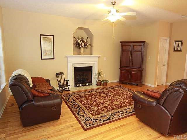 76 Old Tree Court Willow Spring, NC 27592 - Photo 2 of 12 The large family room boasts of gleaming hardwoods, gas fireplace and access to the screened porch! The perfect place to relax at the end of the day! Den/Family/Great Room
